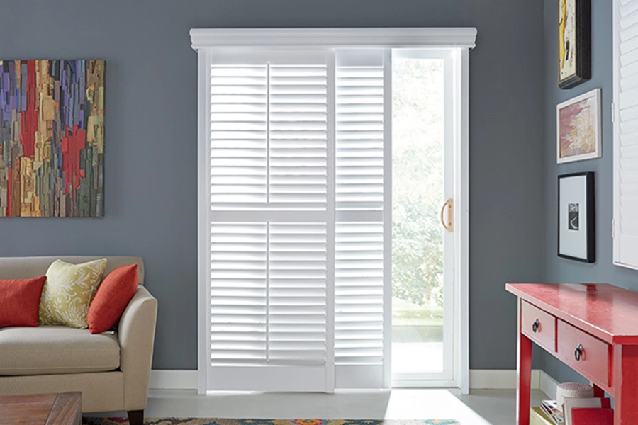 White Polywood shutters on a dining room sliding glass door